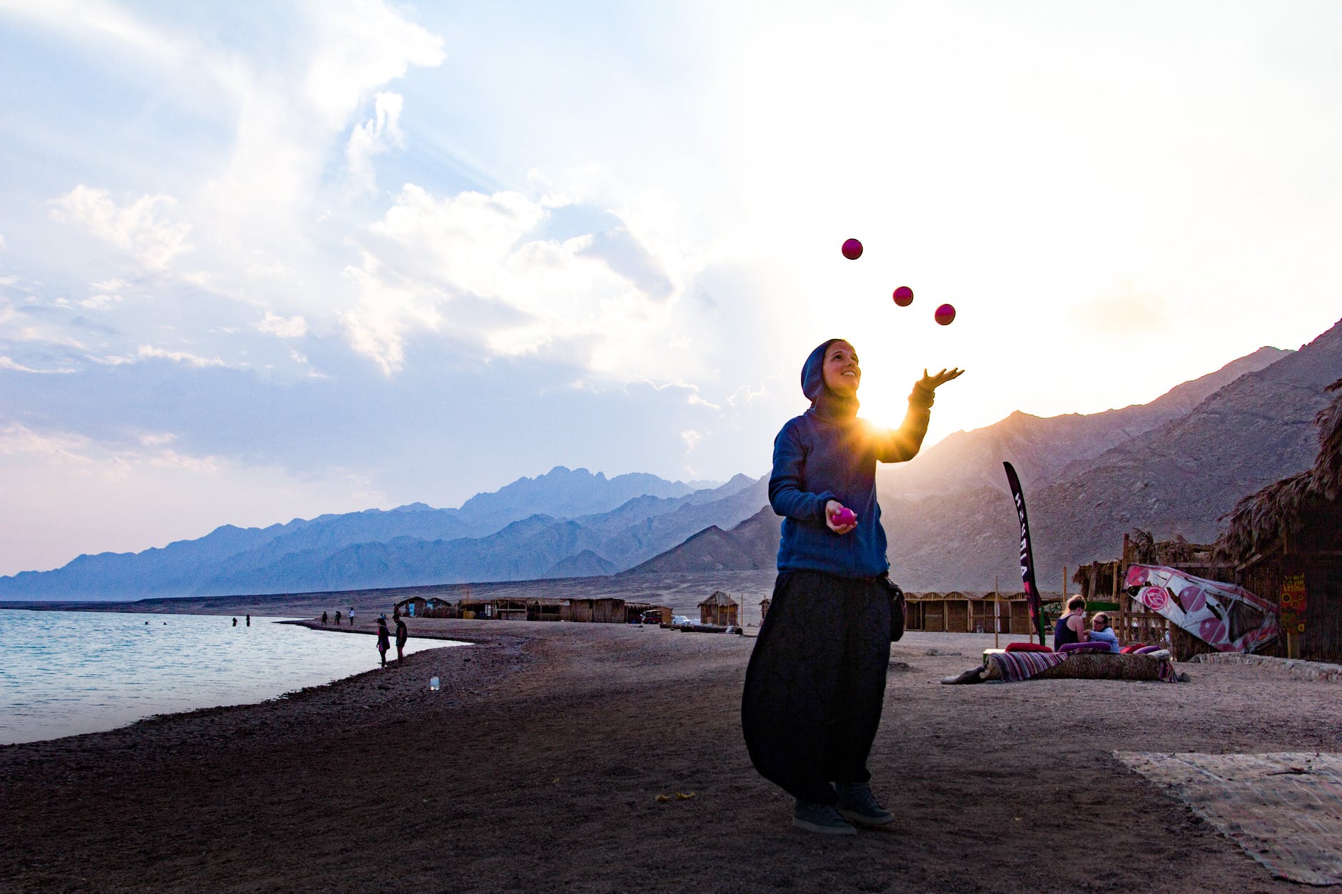 woman at the beach juggling
