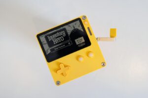 a yellow and black gameboy with a white background